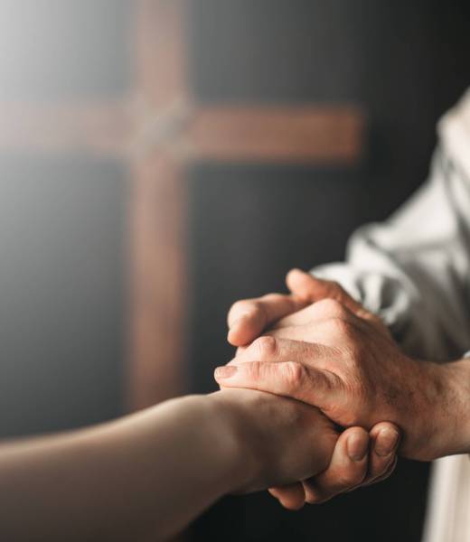 Jesus Christ in white robe gives a helping hand to the faithful, crucifixion cross on background. Son of God, christian faith symbol